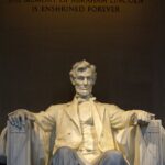 man in yellow dress shirt sitting on chair